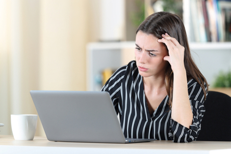 Woman on laptop researching.